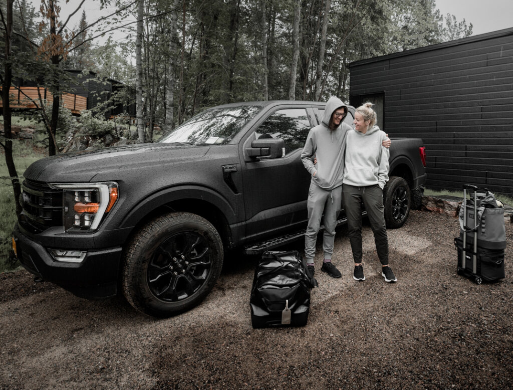 Becki and Chris in front of truck with suitcases