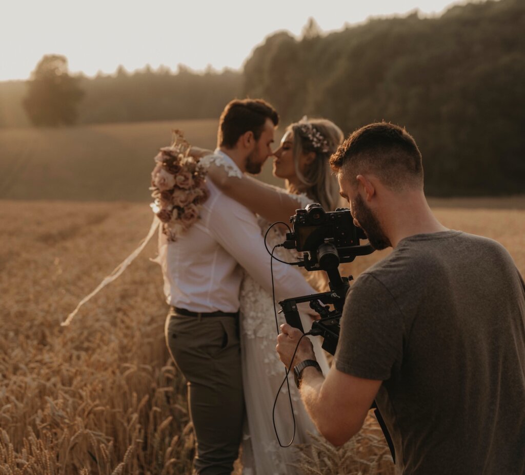 Russell Kent Nicholls photographing bride and groom outside