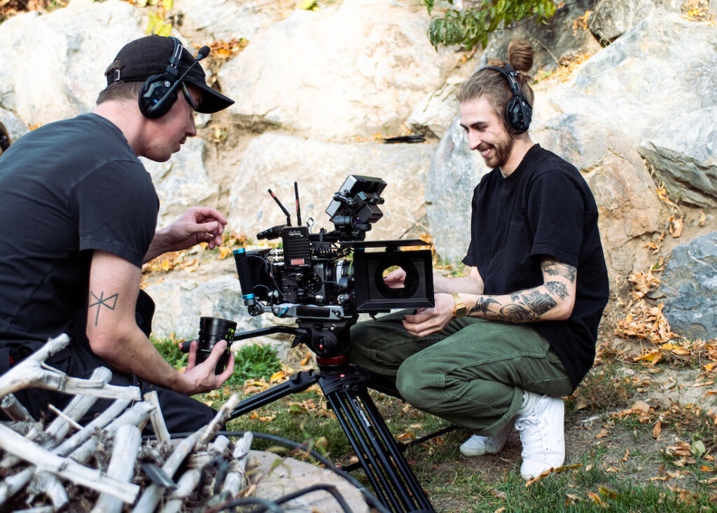 Brady Bessette looking at camera with crew member