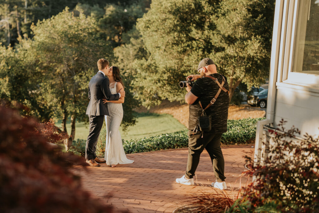 Chase Daley taking photo of couple on wedding day