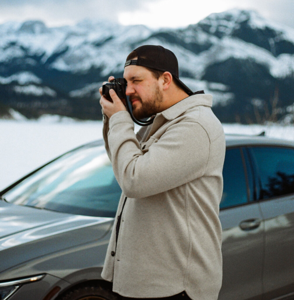 Alexander McInnes taking photo with car background